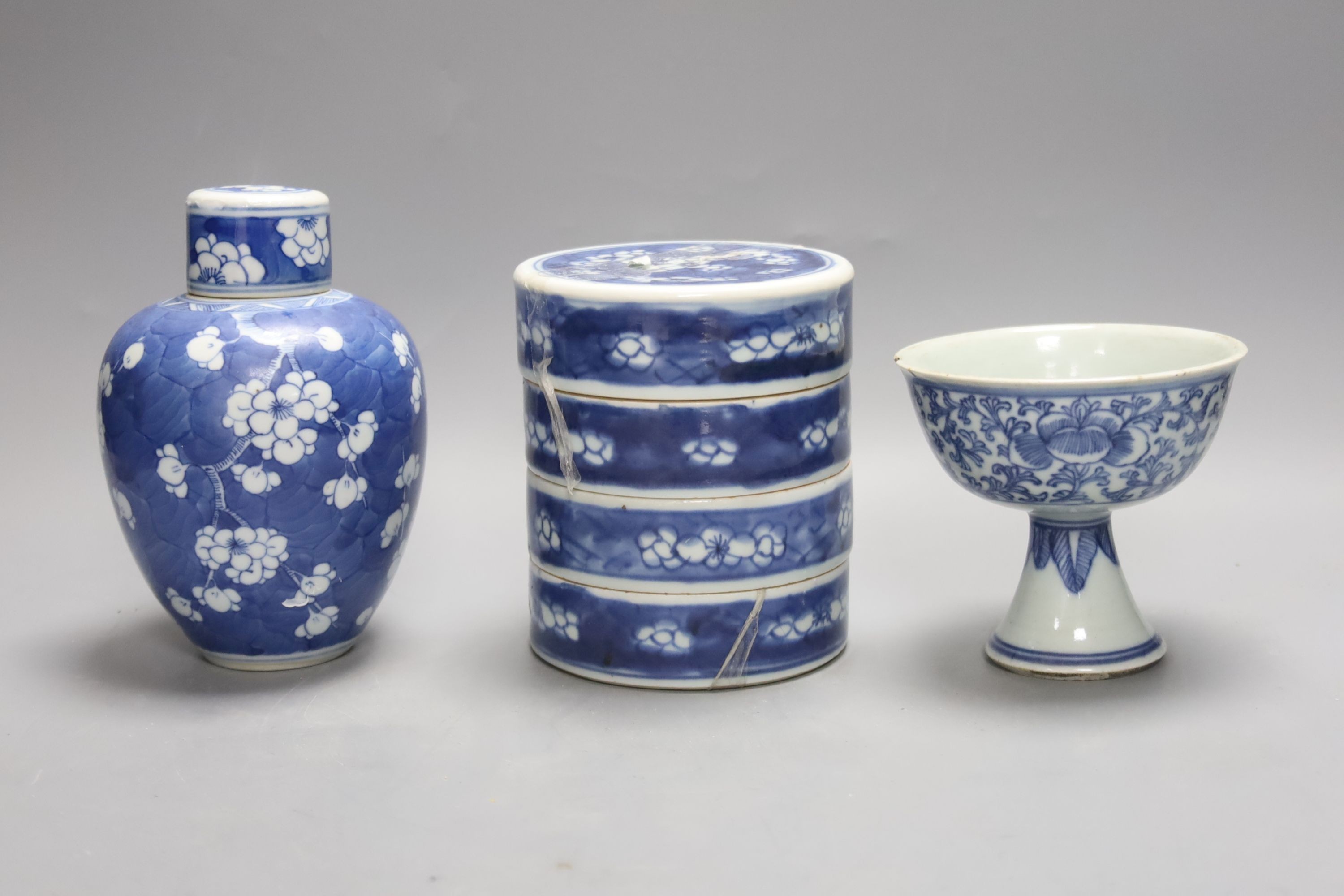 A Chinese blue and white ovoid jar and cover and similar stacking box, Kangxi and a Qing blue and white footed cup, tallest 15cm